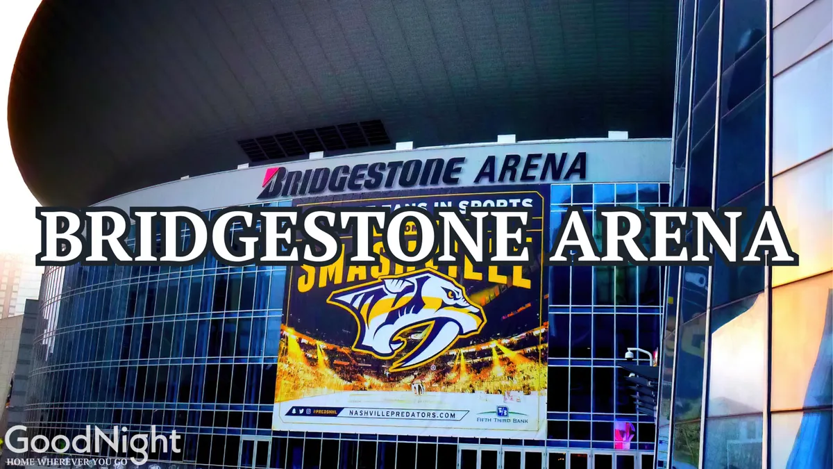 This exterior image showcases Bridgestone Arena, featuring bold signage and the recognizable Nashville Predators banner. The arena's modern architecture is surrounded by the lively atmosphere of downtown Nashville, suggesting easy access to major events and entertainment.